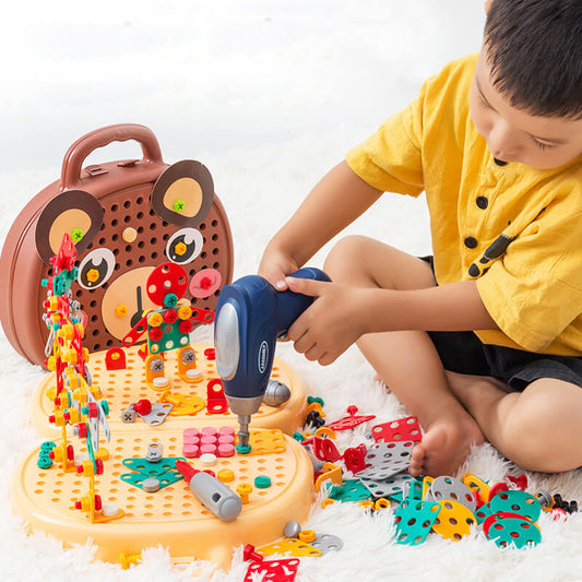Child playing with a toy construction set on a white surface